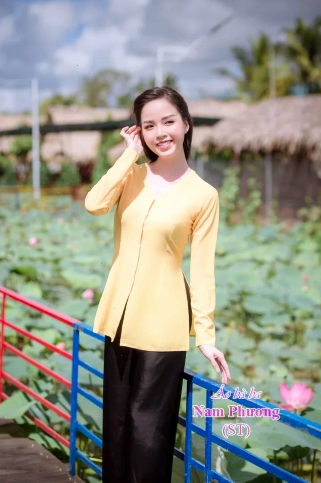 cô gái mặc áo bà ba duyên dáng bên cầu tre